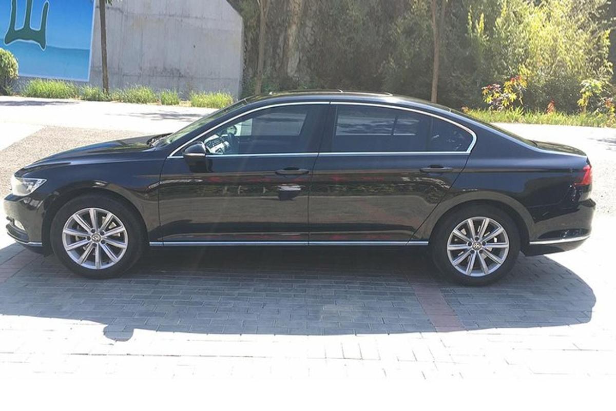 a black car is parked on a street