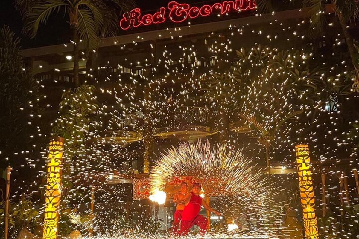 two people standing in front of a fountain with fireworks