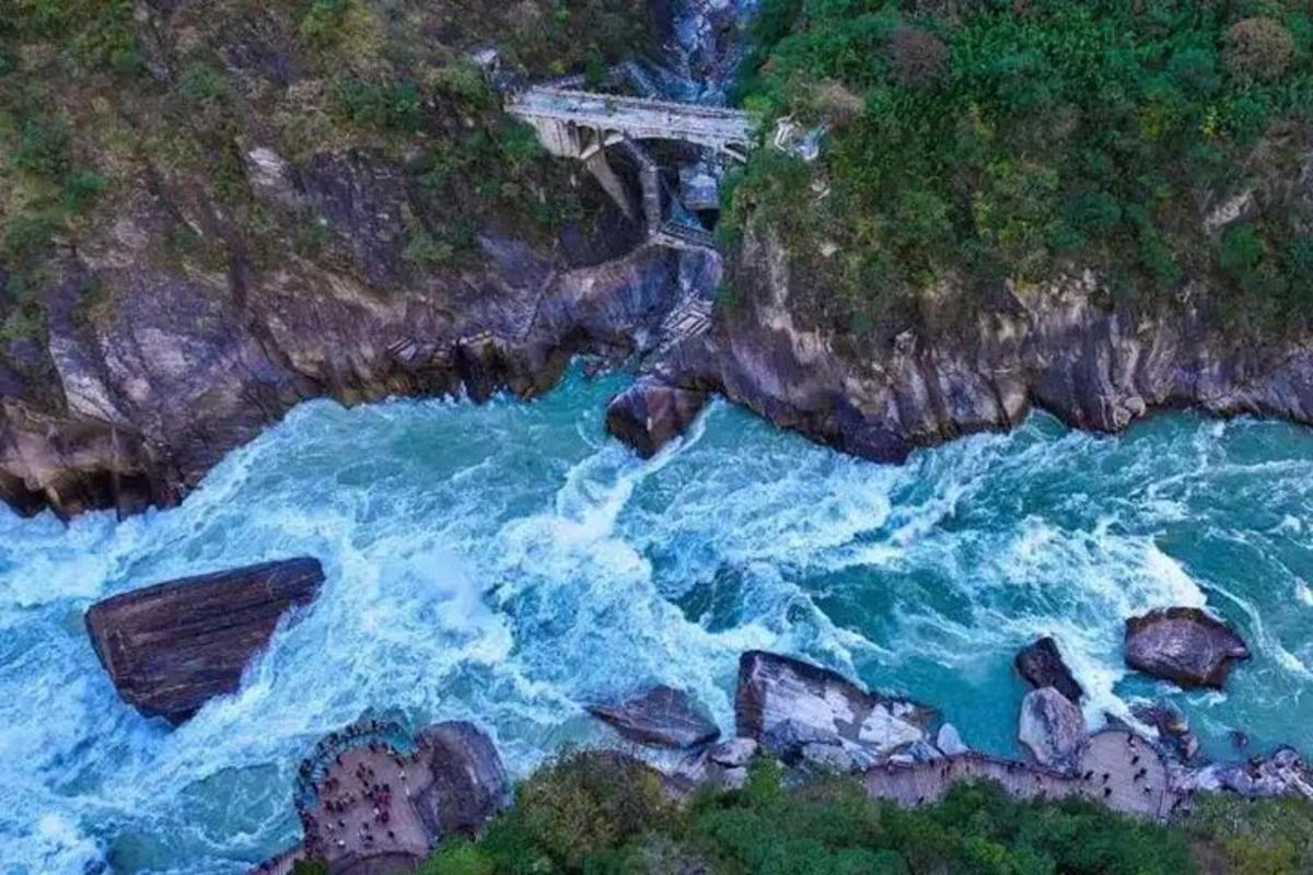 an aerial view of a bridge over a body of water