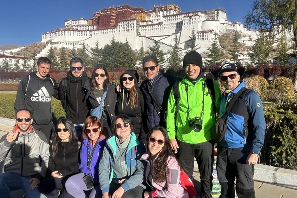 a group of people posing for a picture in front of the palace