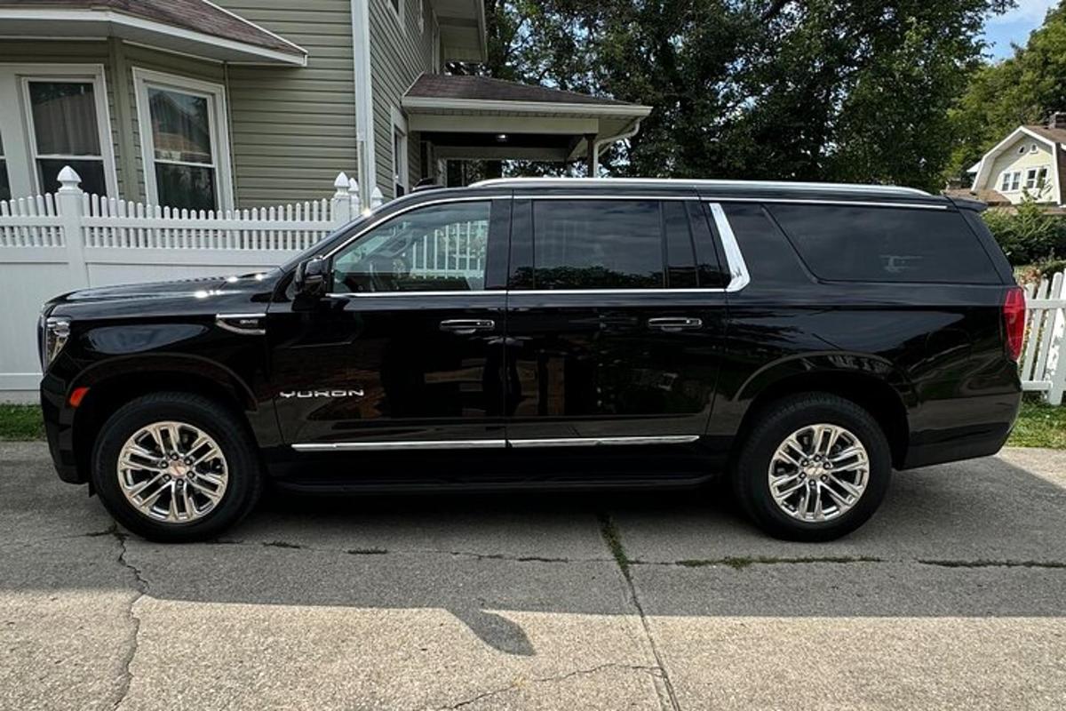 a black suv parked in front of a house