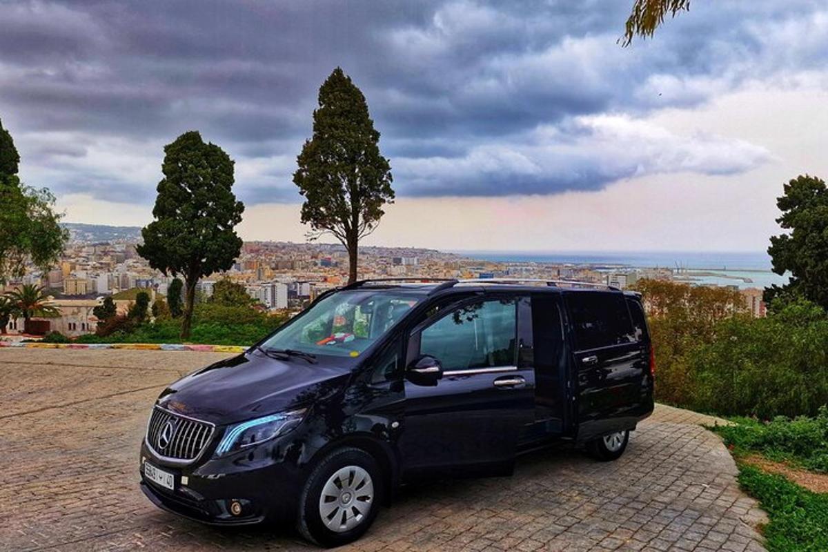 a black car parked on a brick road