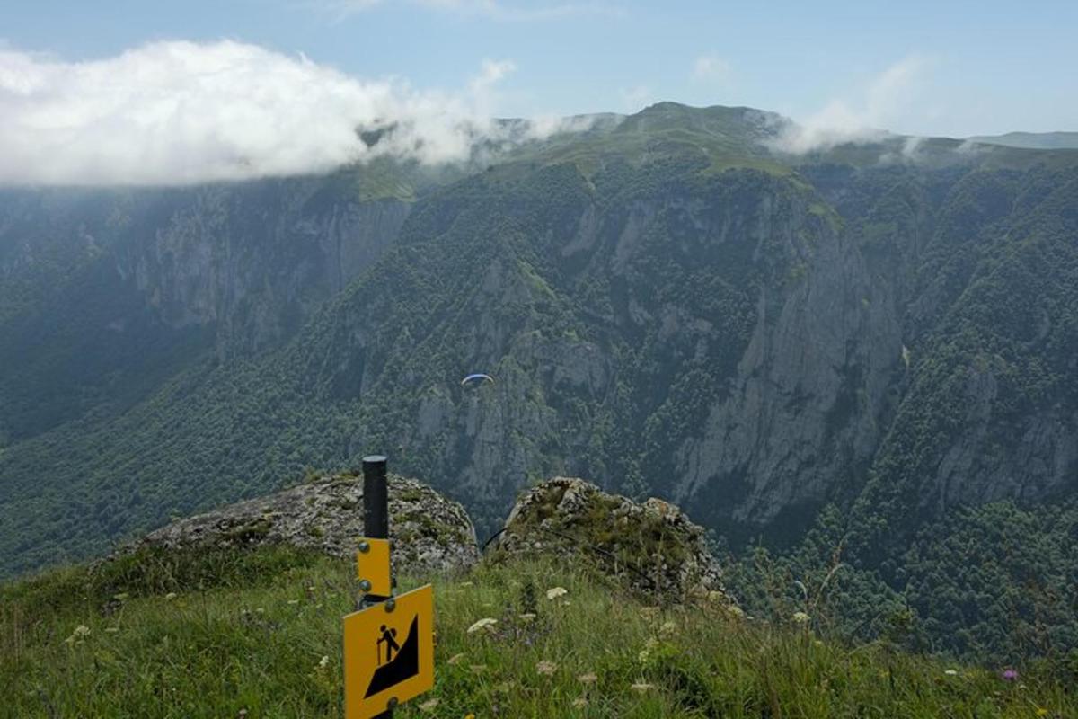 a sign on top of a mountain with a view