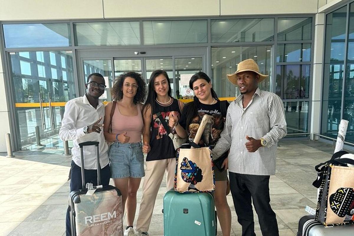 a group of people standing with luggage in an airport