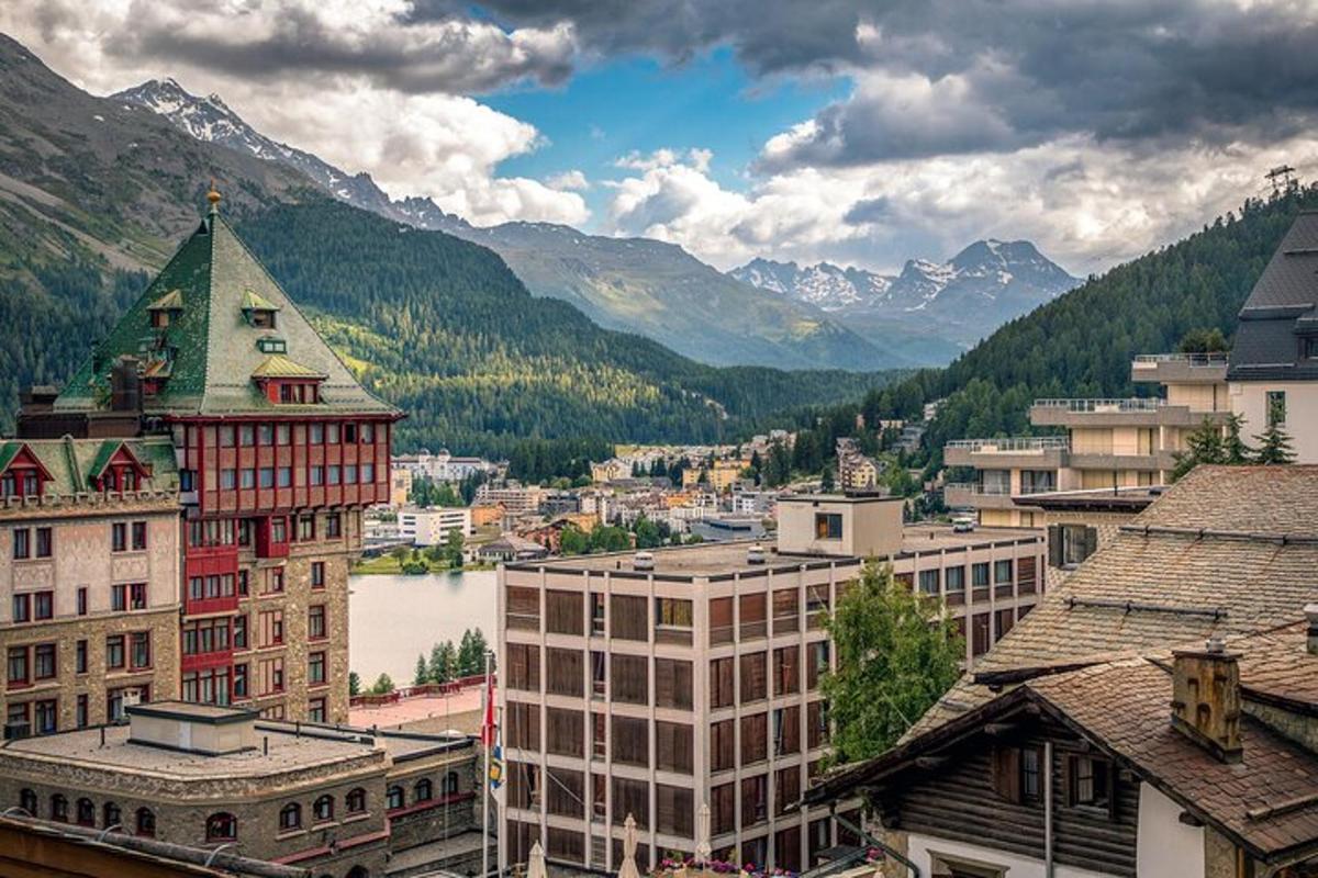 a city with buildings and a river and mountains