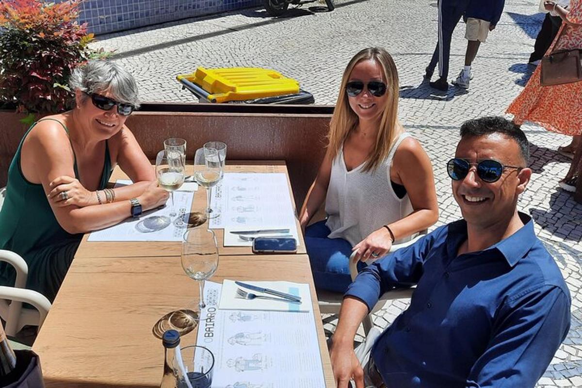 a group of people sitting at a table with wine glasses