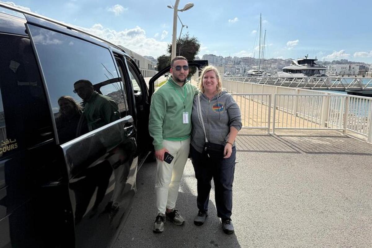 a man and a woman standing next to a van