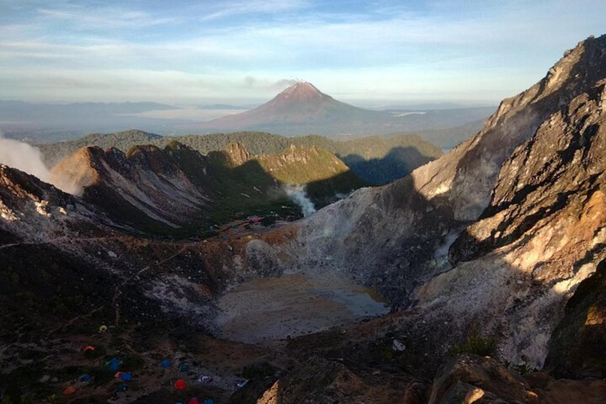 a view of a mountain with a volcano in the background