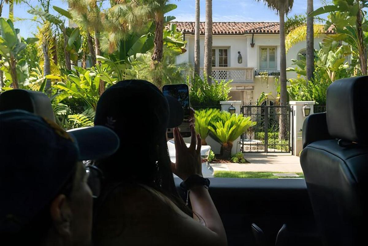 a woman taking a picture of a house