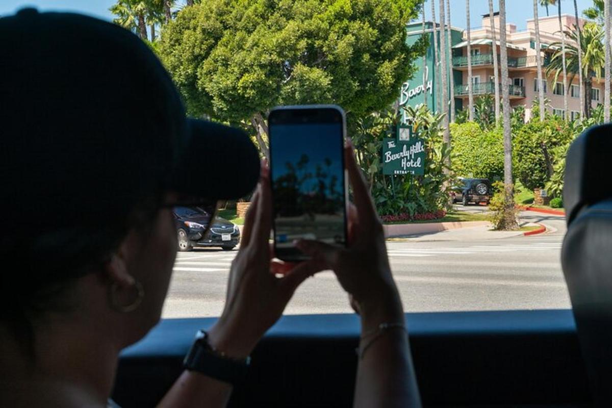 a person taking a picture of a street with a cell phone