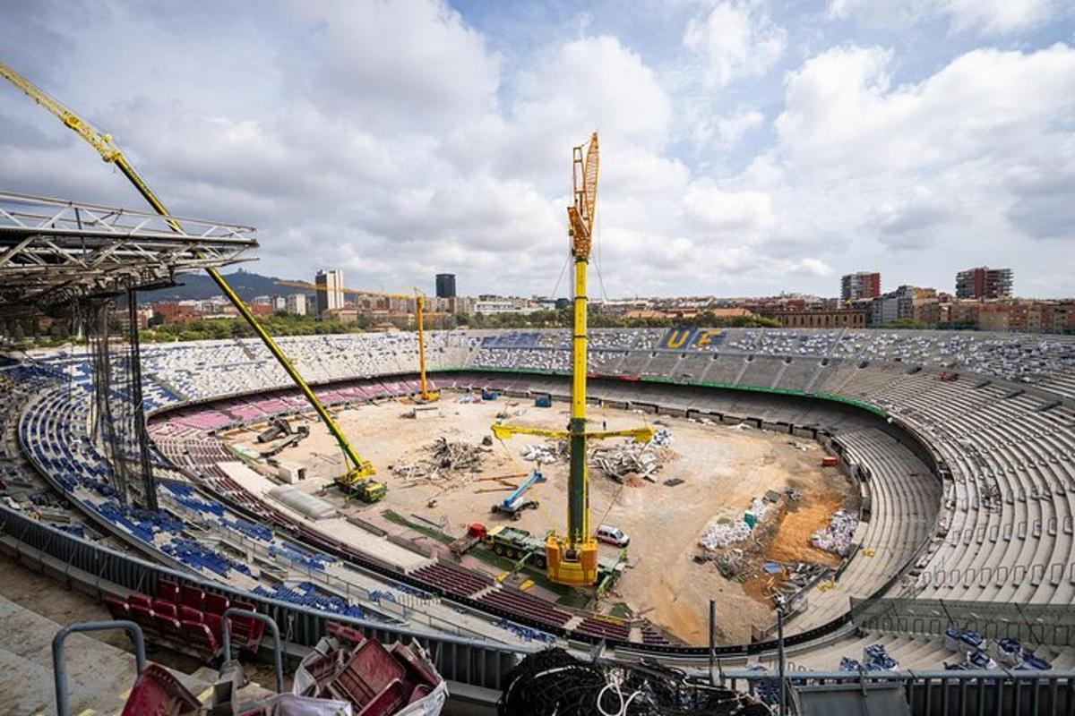 a construction site of a soccer stadium with construction equipment