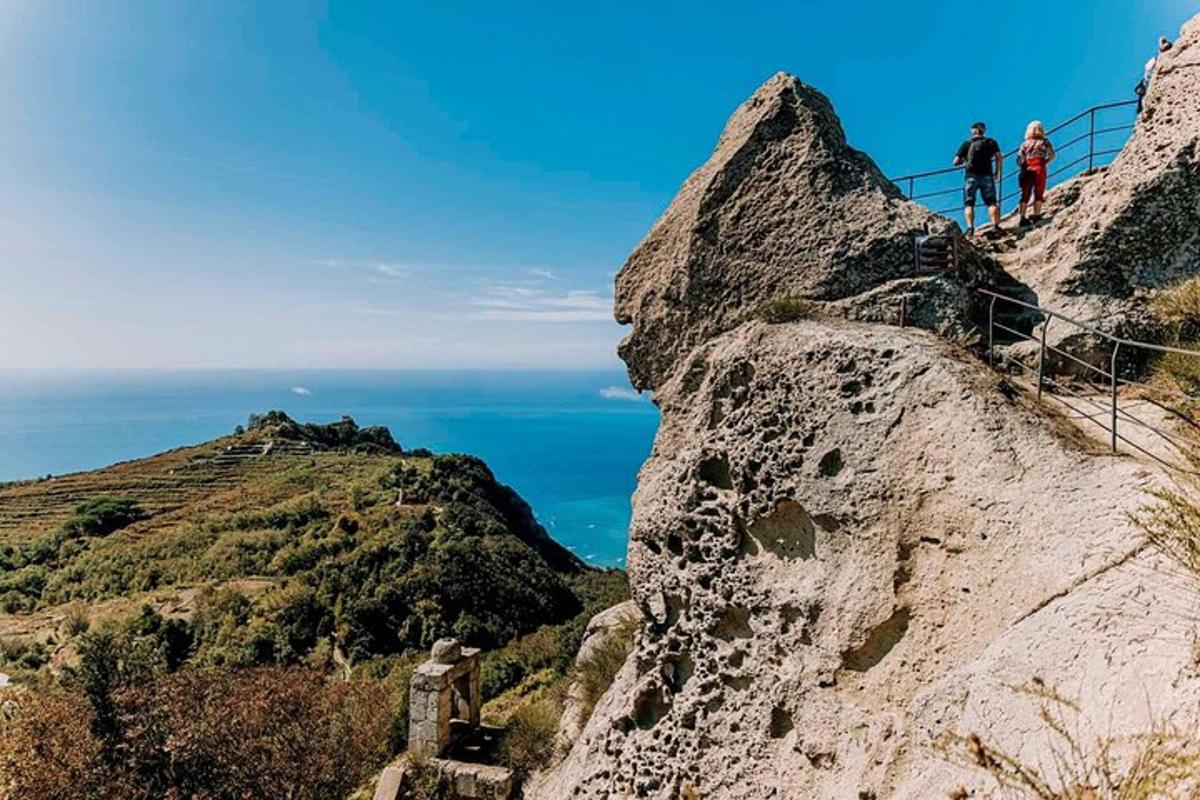 a group of people walking up the side of a mountain