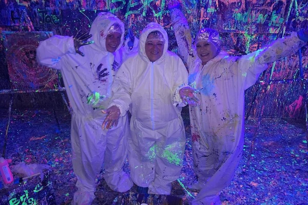 a group of three people dressed in white posing for a picture