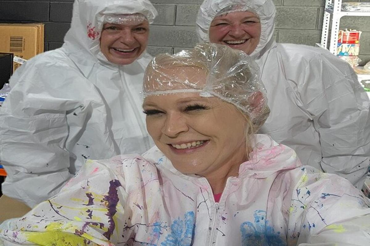 three chefs standing next to a woman with a baby