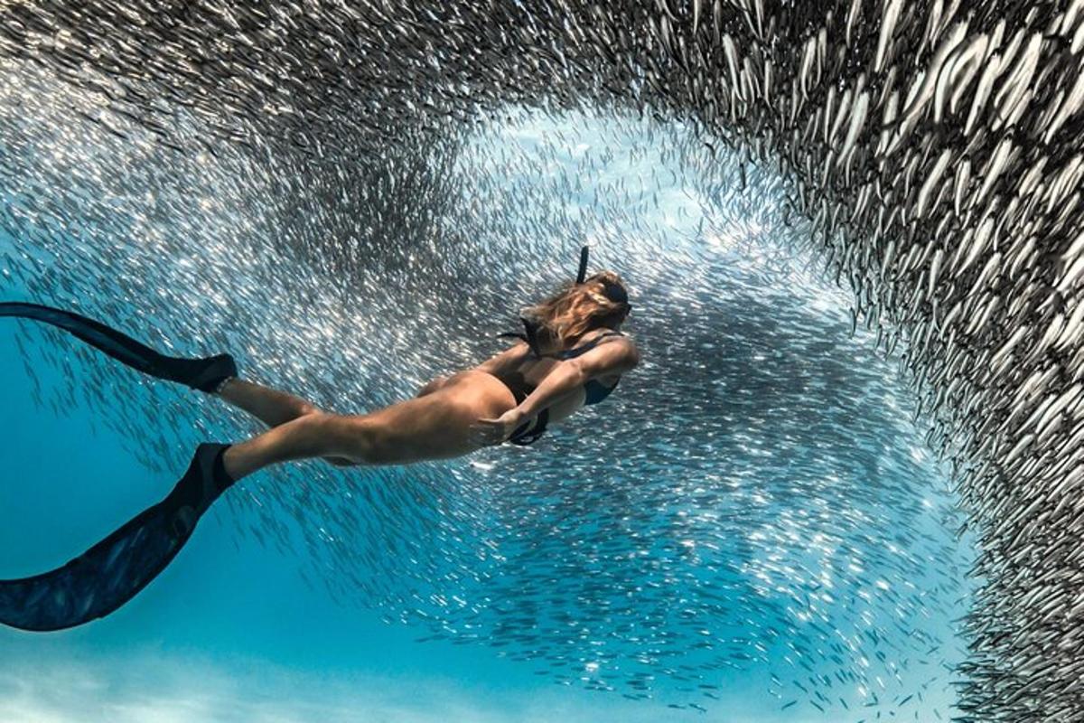 a woman riding a wave on a surfboard in the water