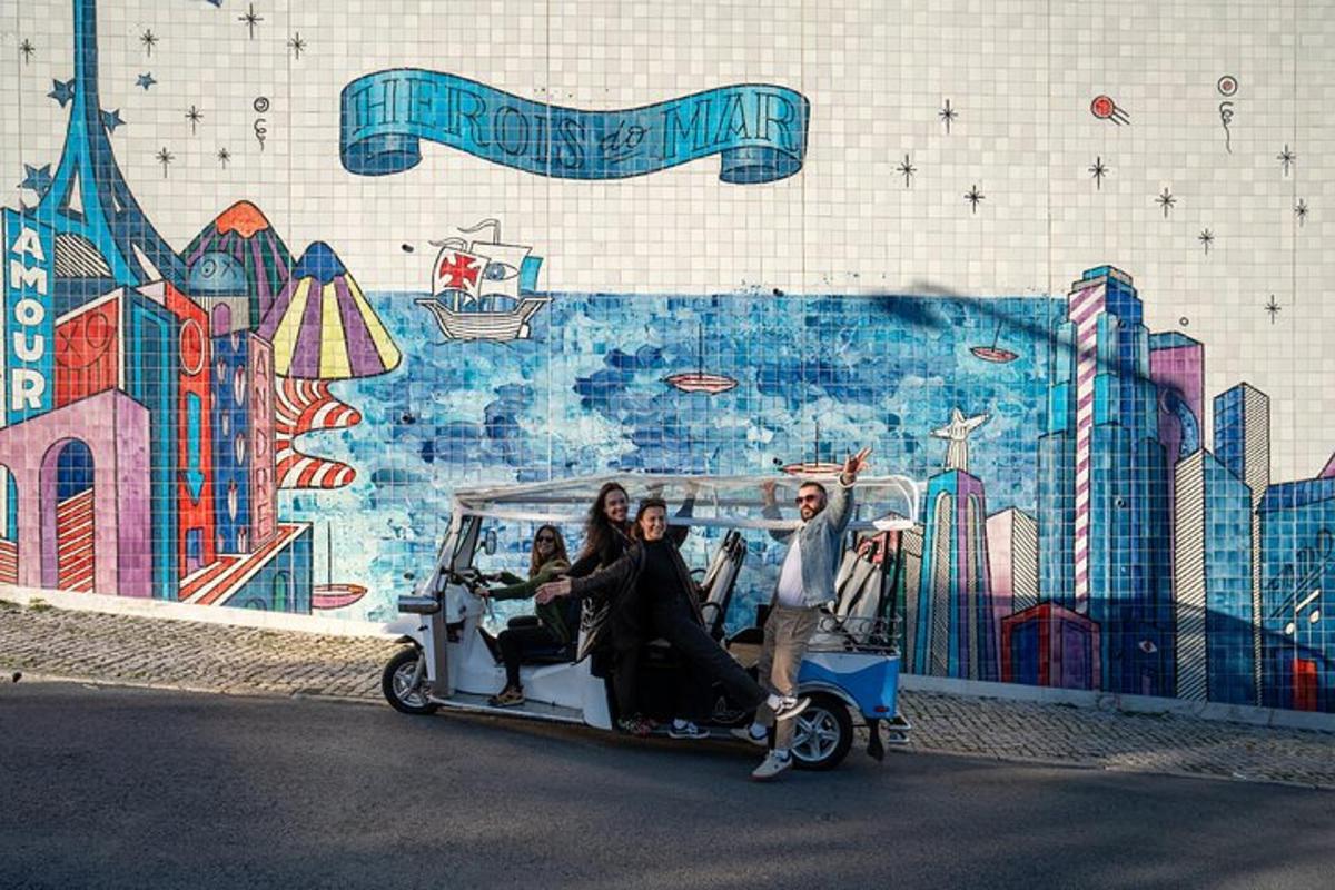 un gruppo di persone su un golf cart davanti a un murale