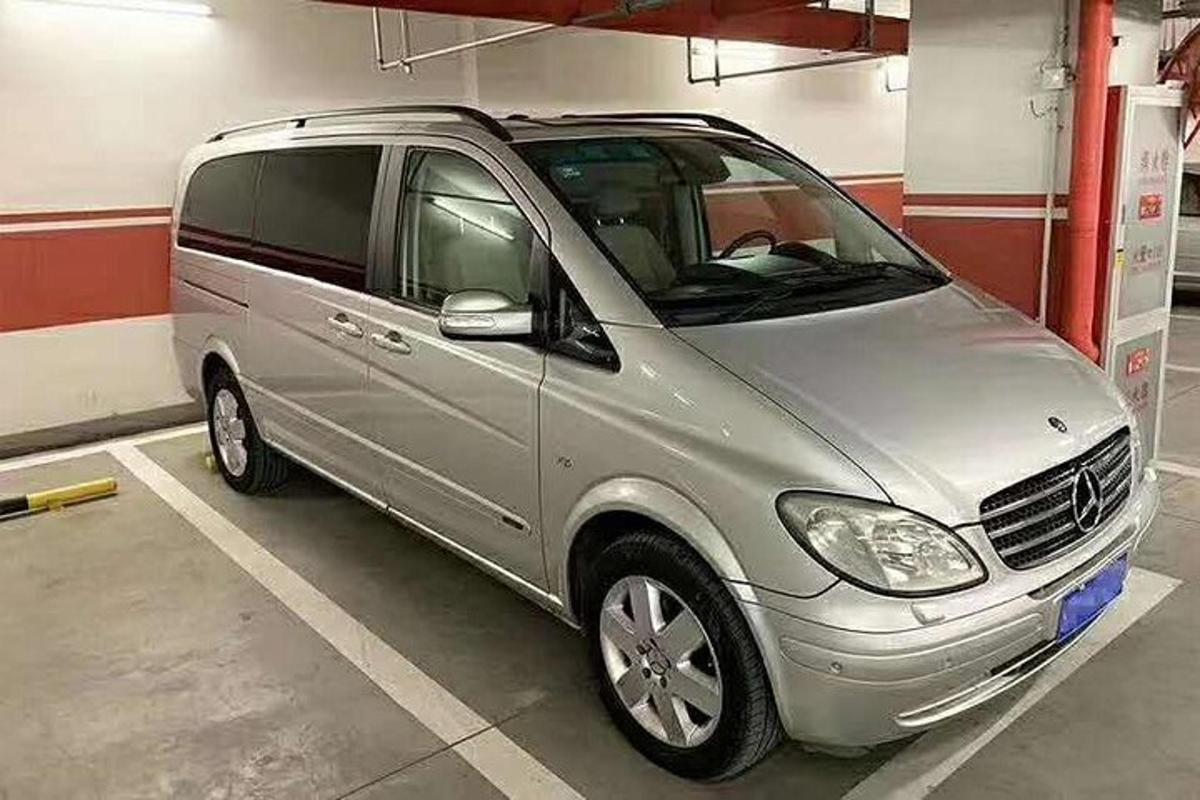 a small silver van parked in a garage