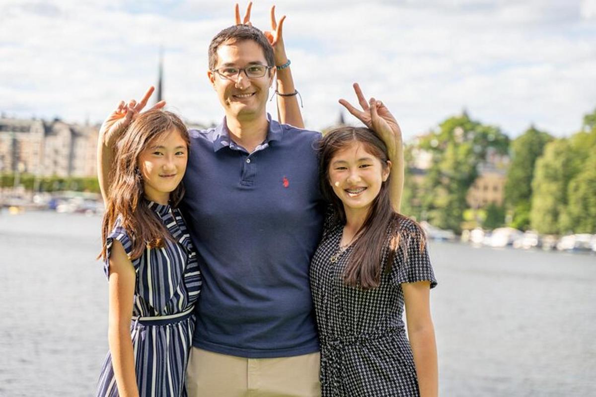 a man and two women with their hands in the air