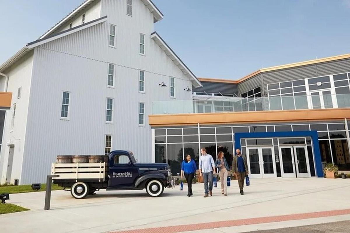 a group of people walking outside of a building with a truck