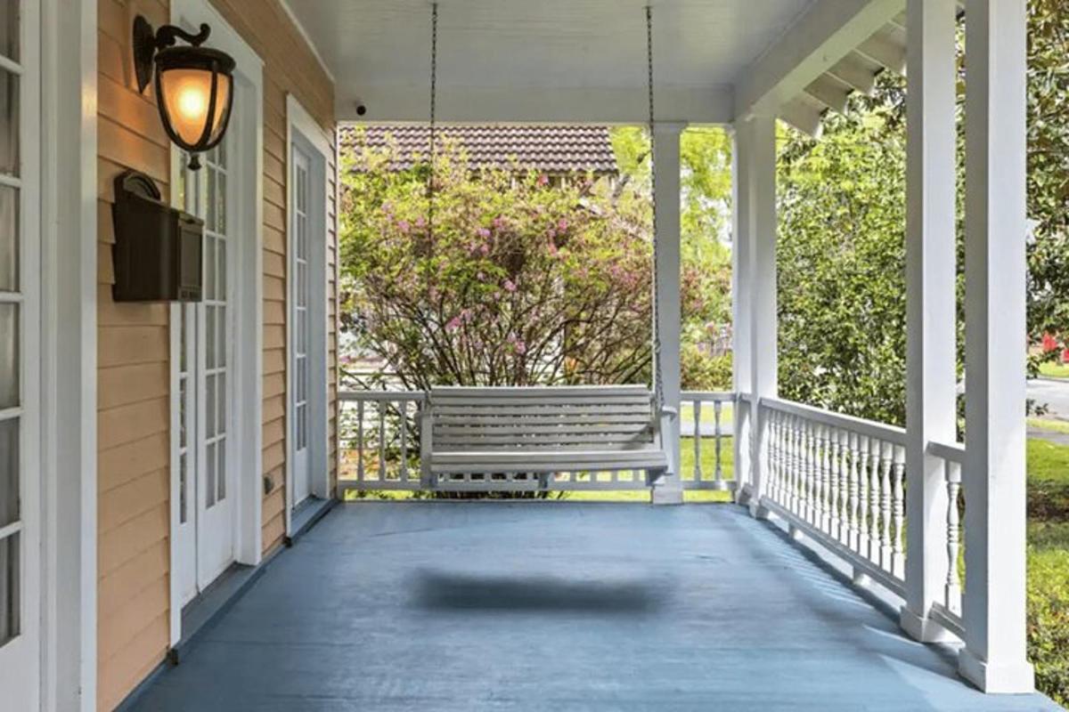 a porch with a bench on a house