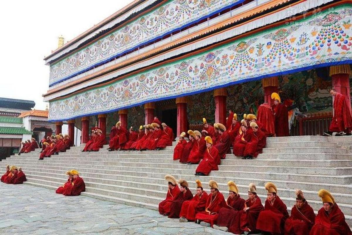 a group of people sitting on steps in front of a building