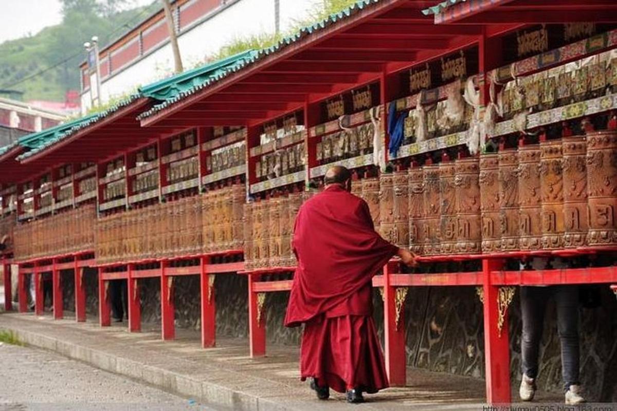 a man in a red robe walking in front of a building