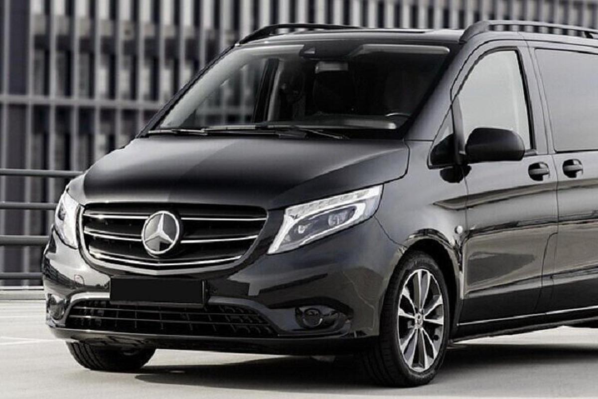 Silfurlitaður Mercedes Benz sendibíll lagður á bílastæði