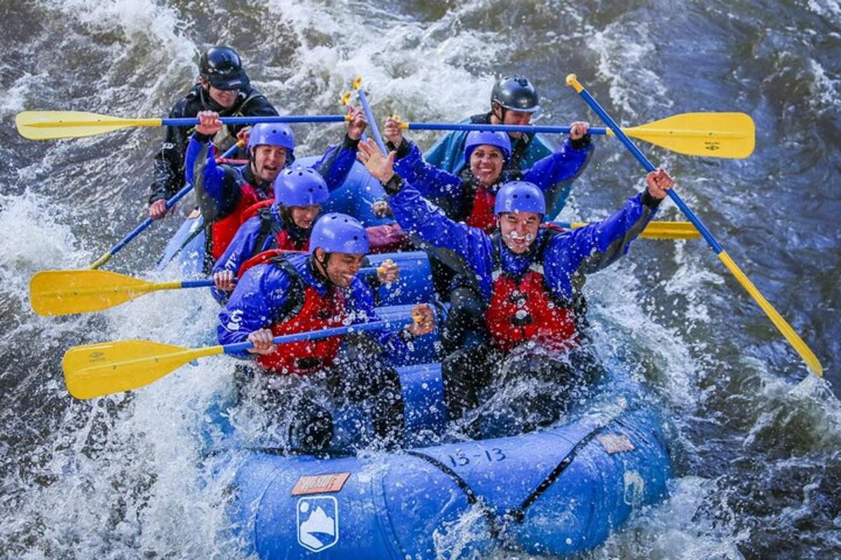 a group of people in a raft in the water