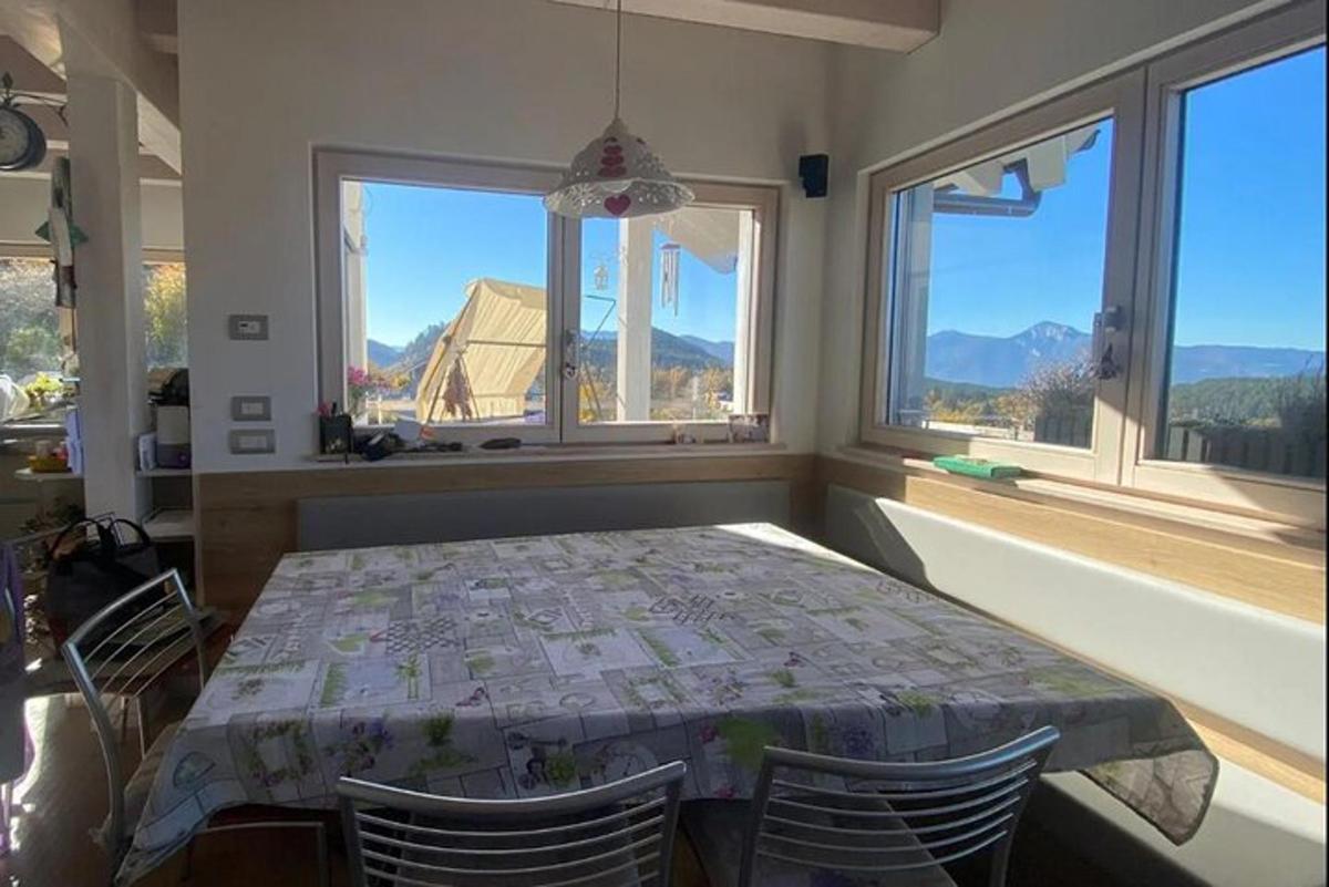 a dining room with a table and some windows