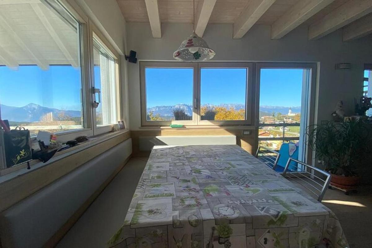 a room with a bed in a room with windows