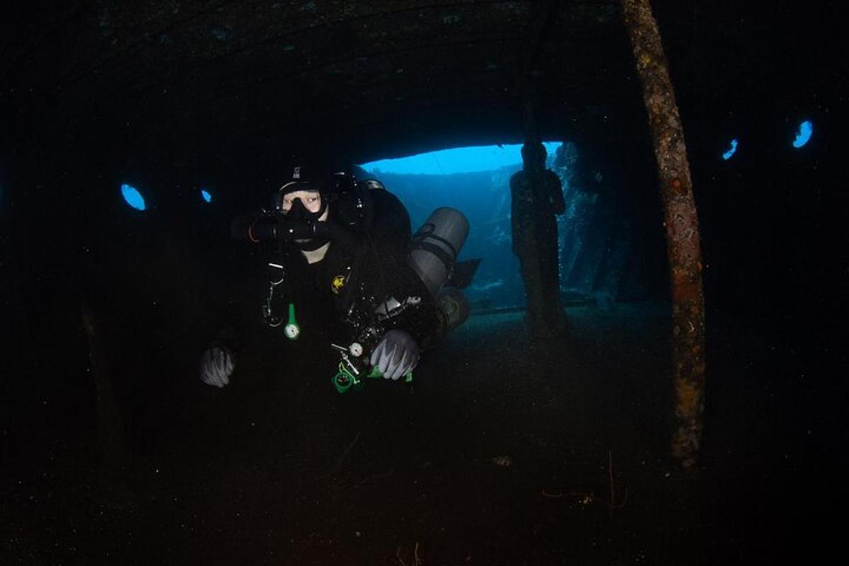 a person with a camera in a dark cave