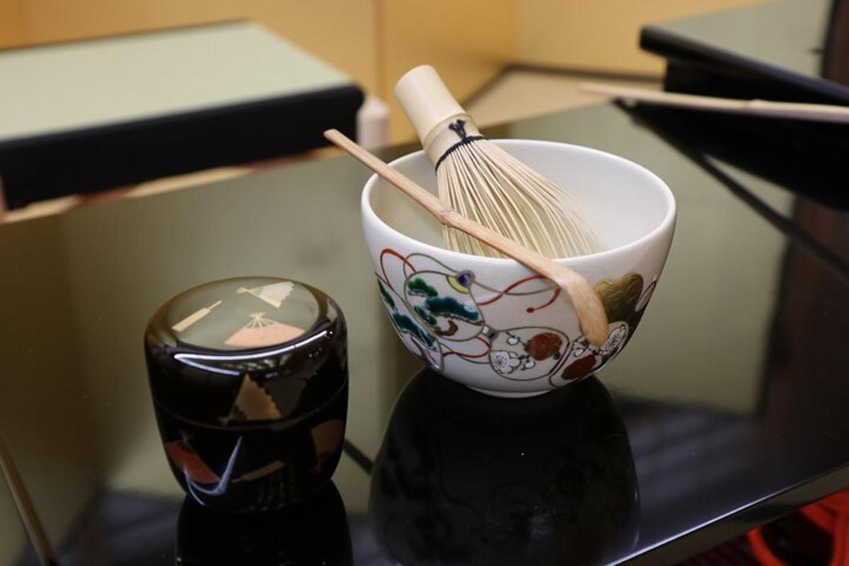 una tazza con una frusta e una scopa su un tavolo