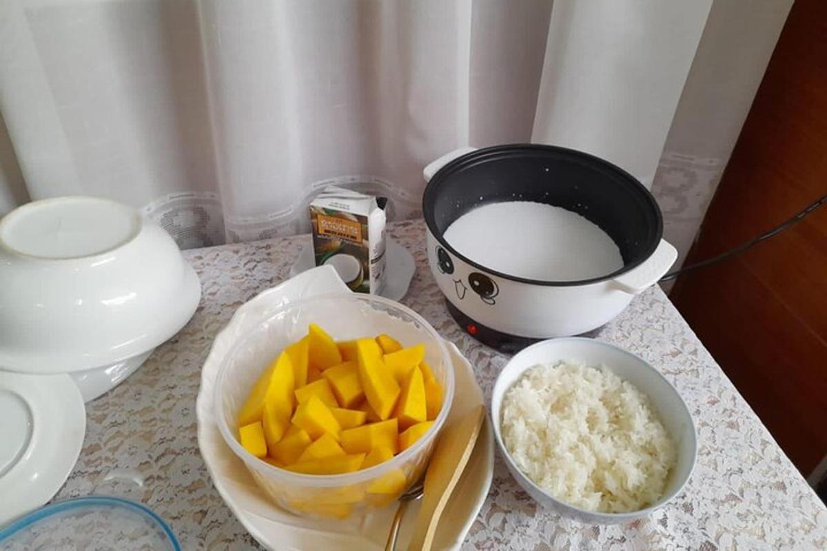 a counter with a bowl of fruit and a bowl of rice