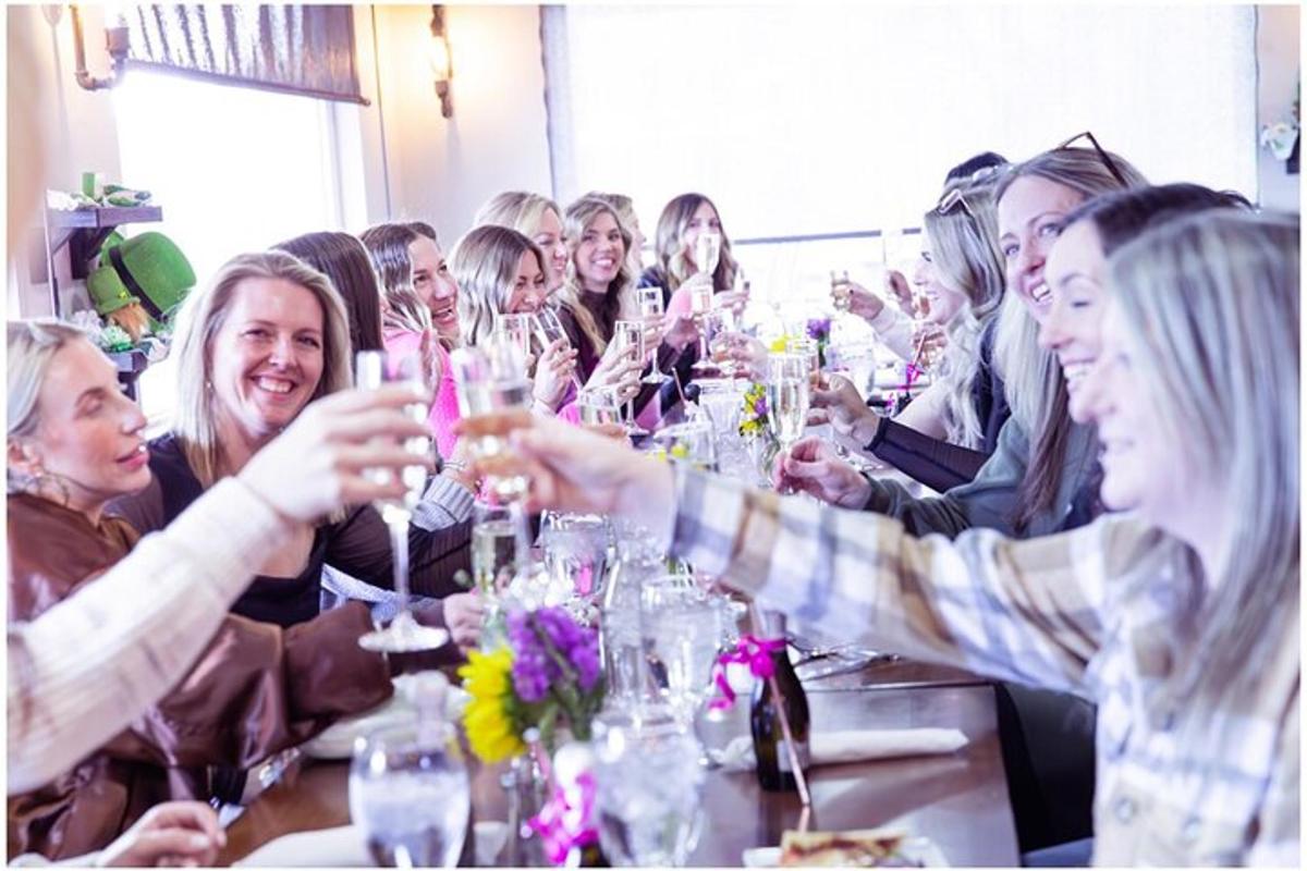a group of people sitting at a table drinking wine