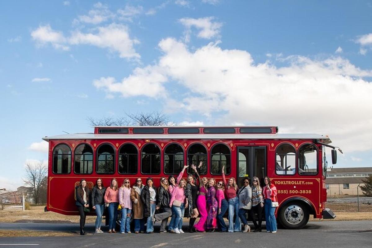 a group of people standing in front of a red bus