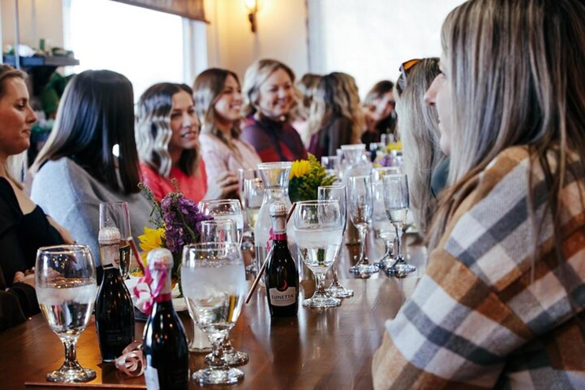 a group of people sitting at a table with wine glasses
