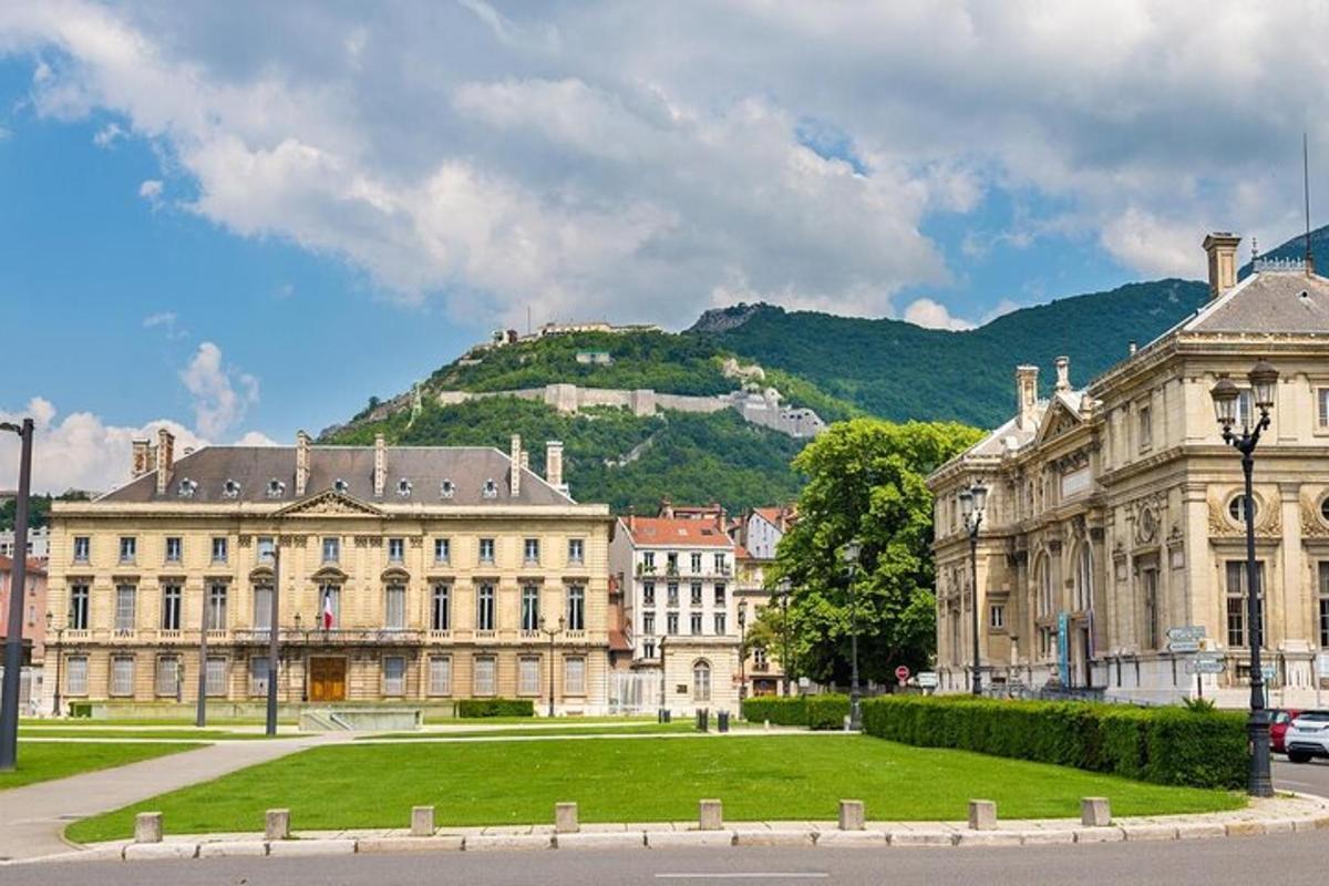 a large building with a hill in the background