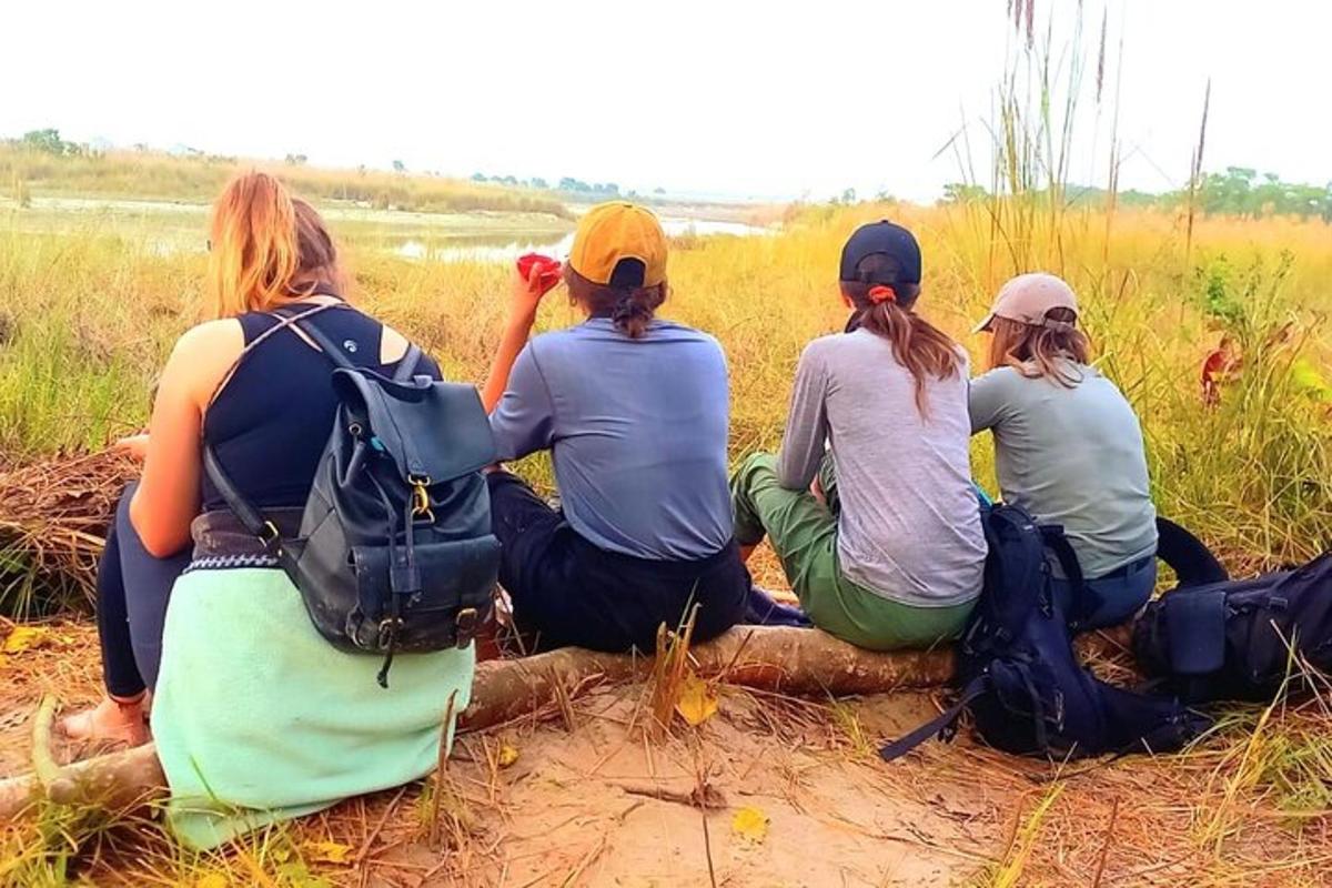 a group of women sitting on a tree log