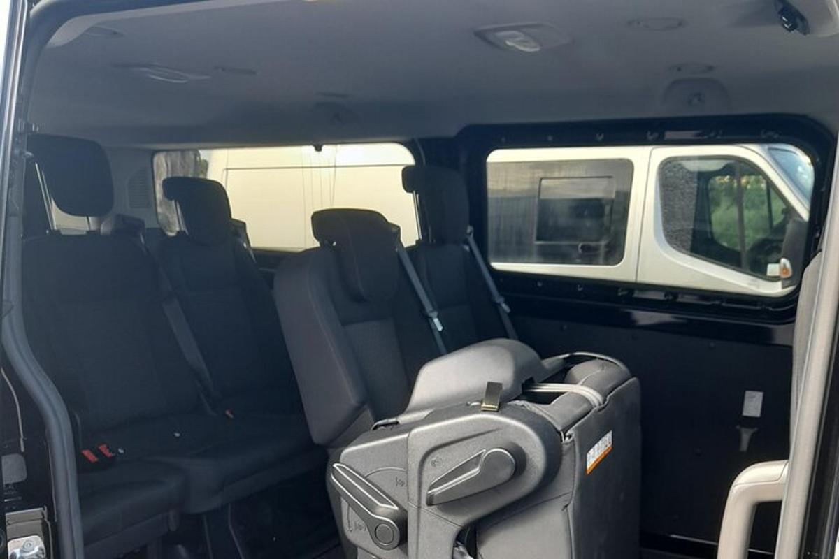 transportlīdzekļa aizmugurējais sēdeklis ar tajā esošo čemodānu