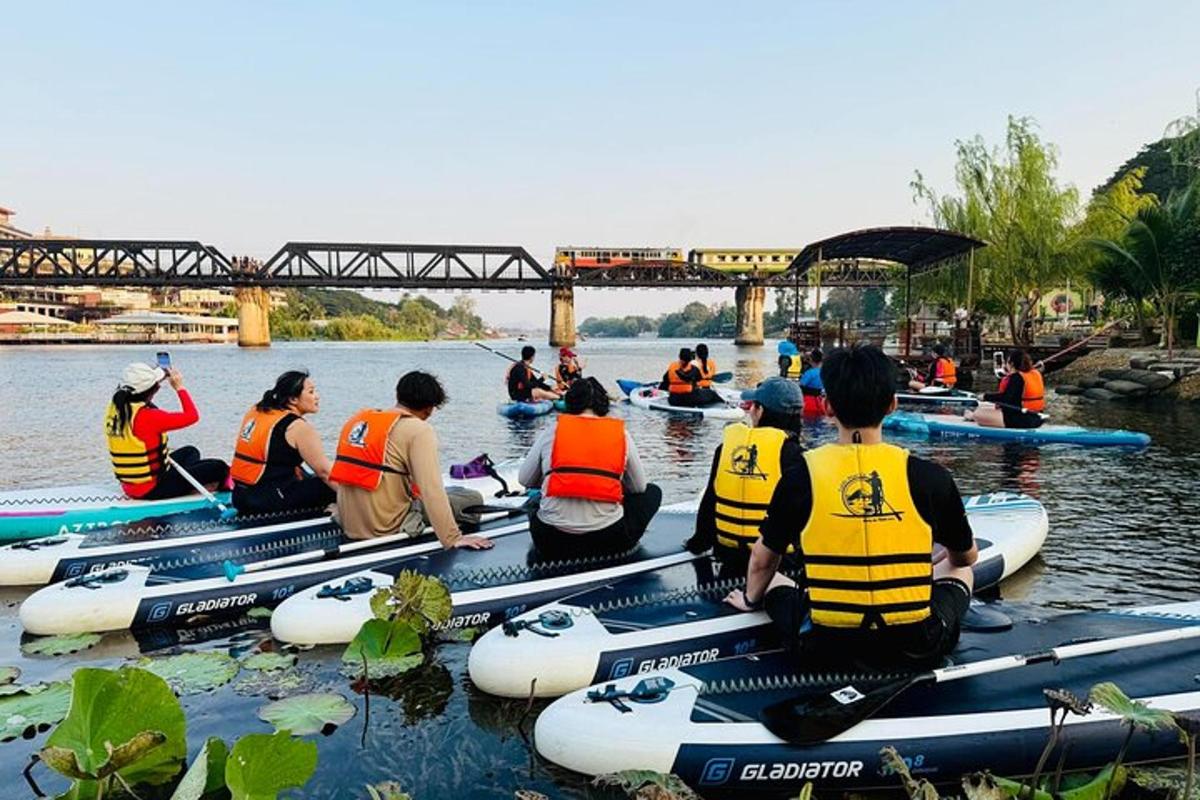 a group of people sitting on kayaks in the water