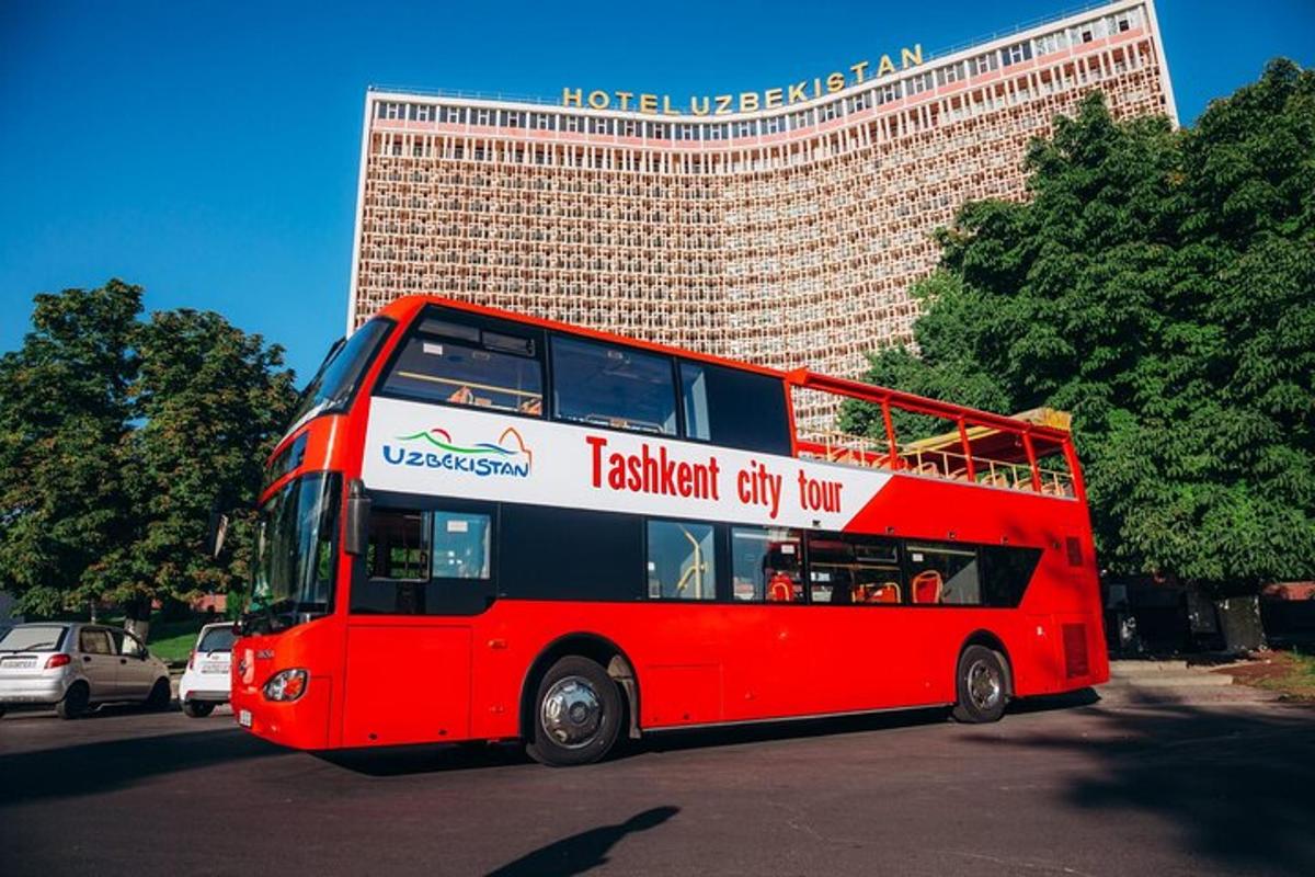 a red double decker bus parked in front of a building