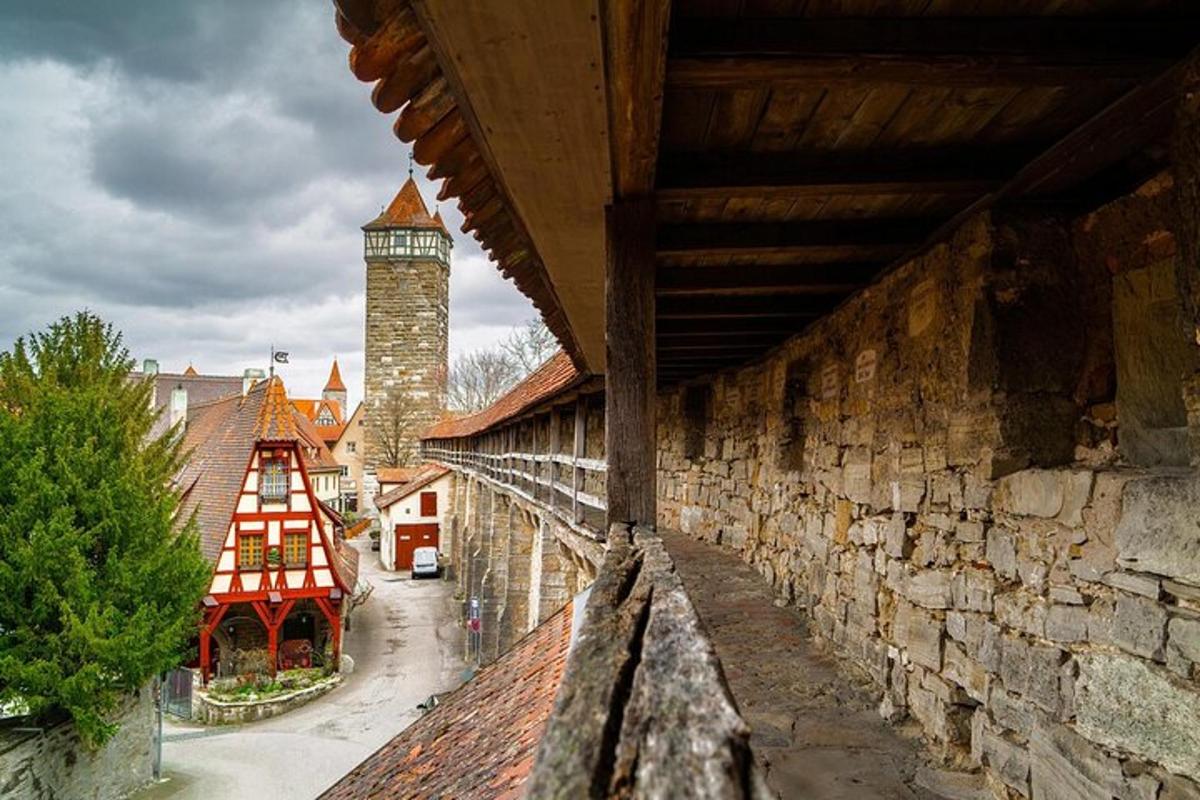 a stone wall with a clock tower in the background