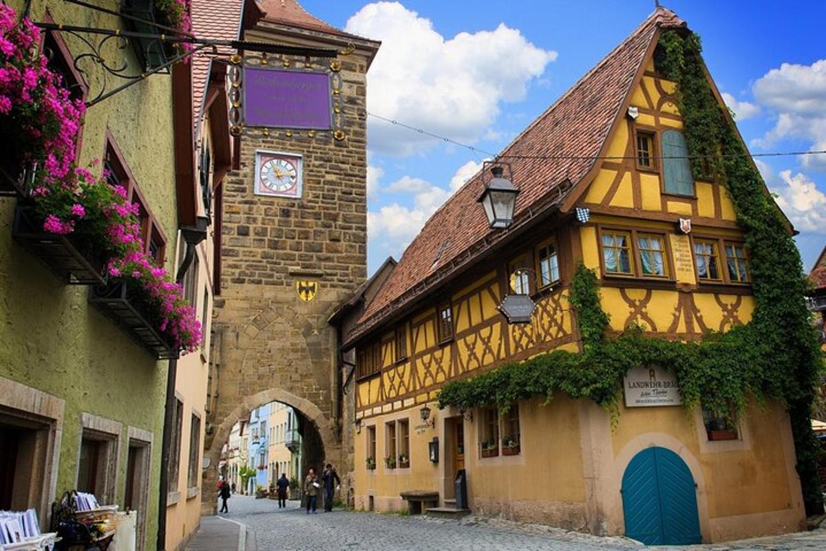 a yellow building with a clock tower on a street