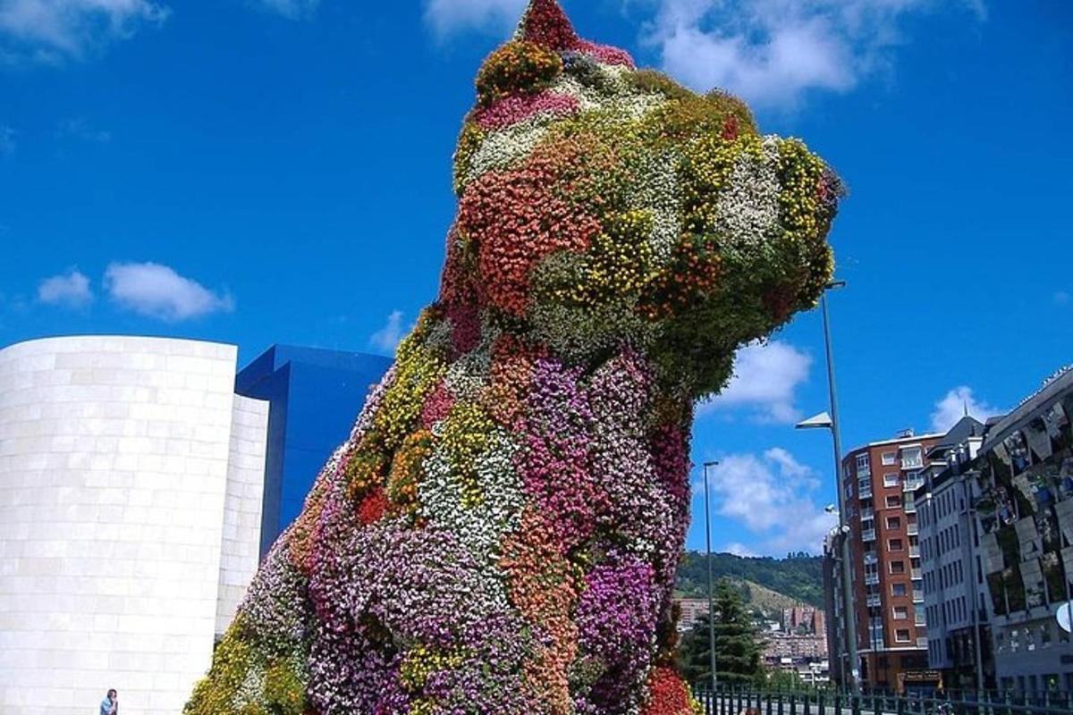 a large sculpture of a teddy bear covered in flowers