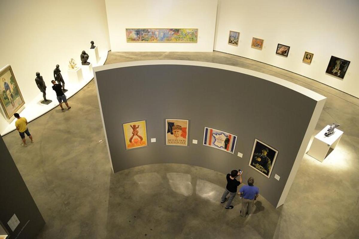 a group of people looking at art in a museum
