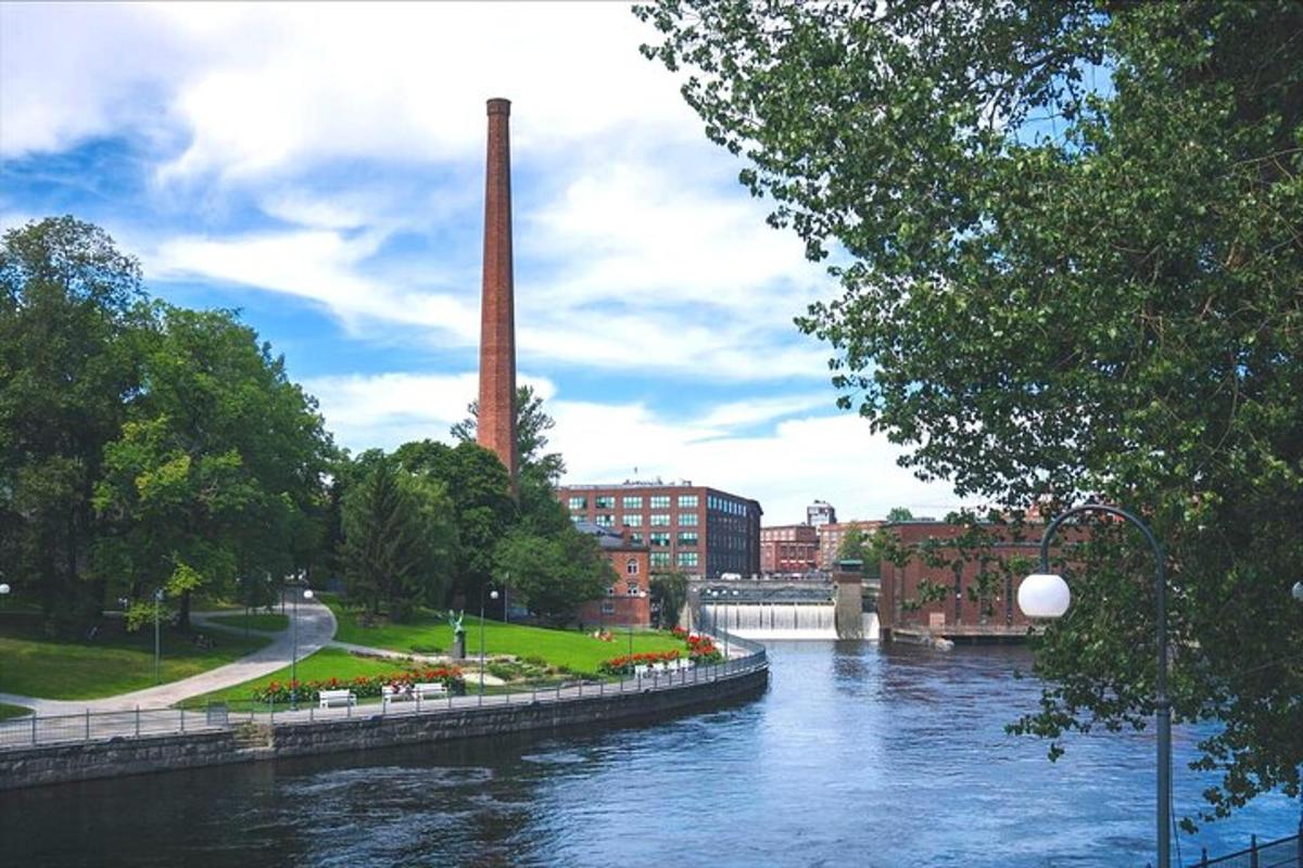 a view of a river with a factory in the background