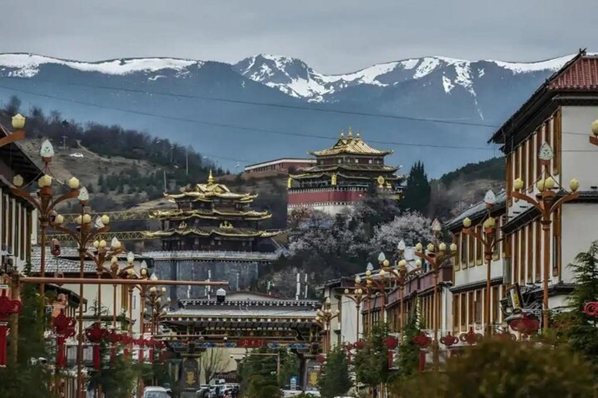 a street with buildings and mountains in the background