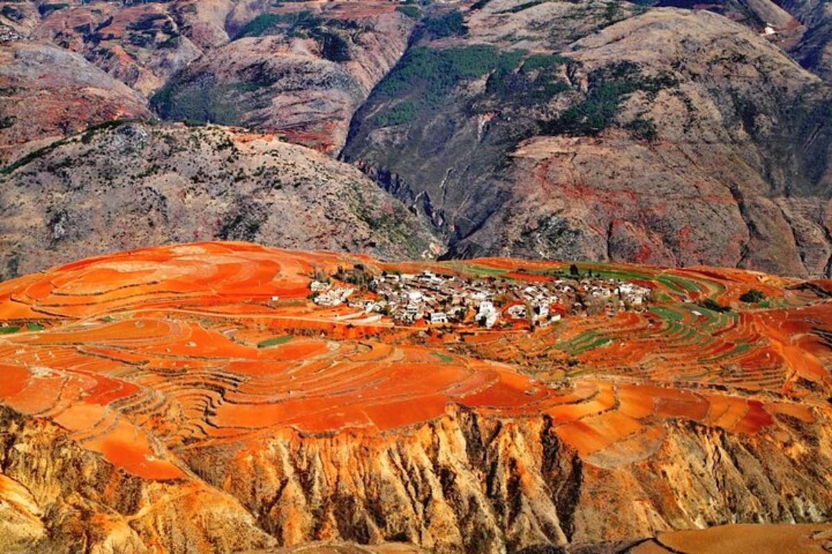an aerial view of a mountain with a village on it