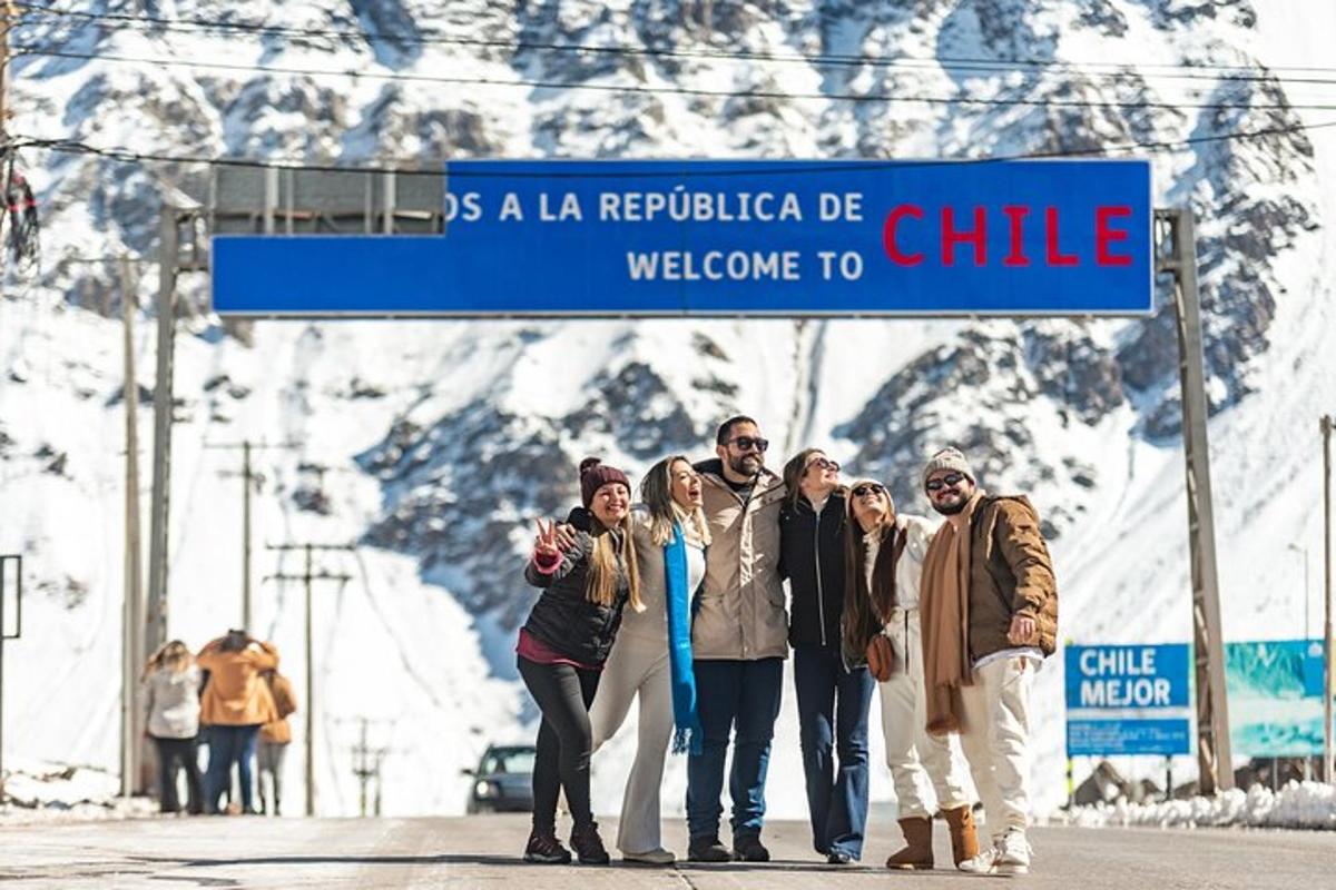 a group of people standing under a blue street sign