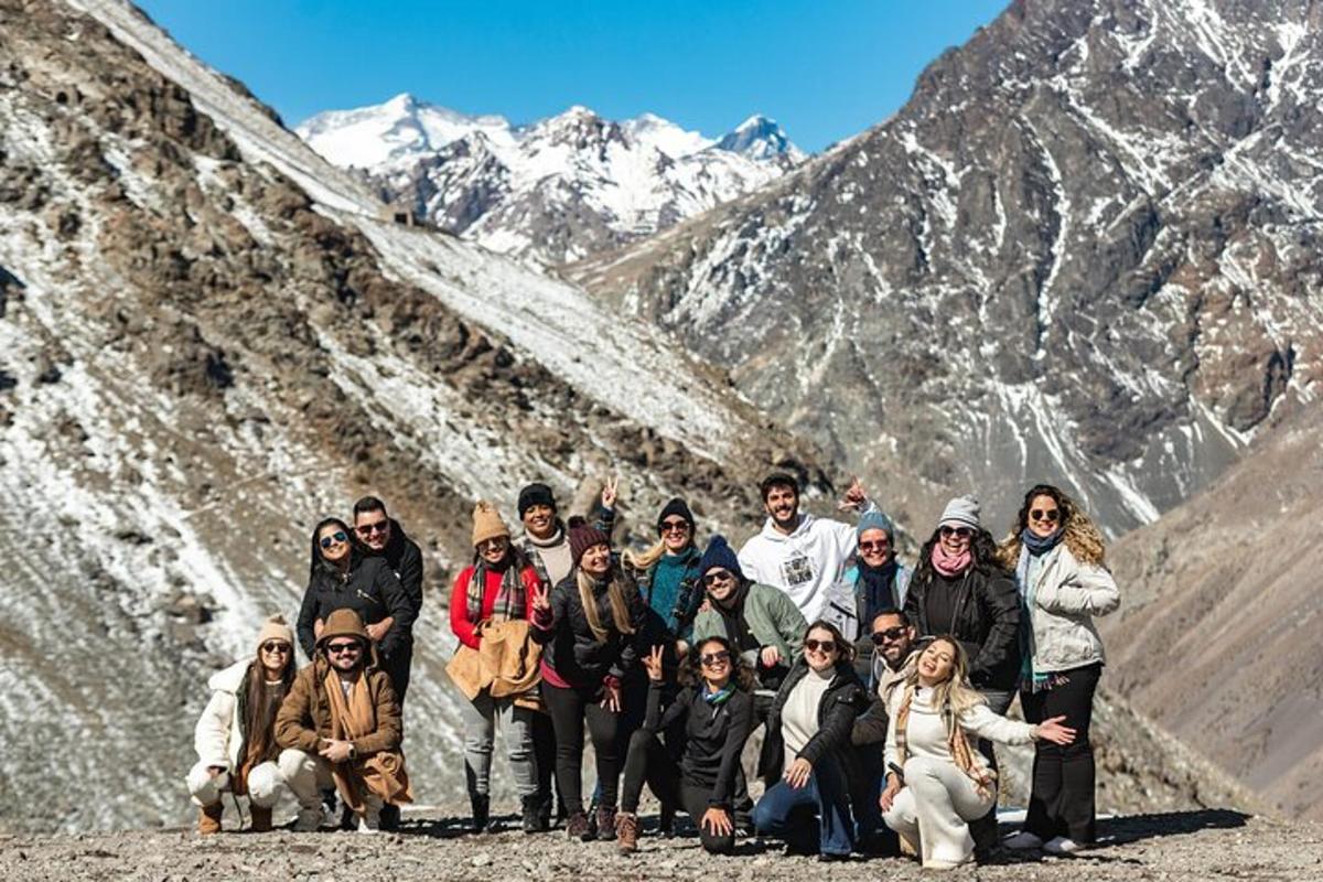 a group of people posing for a picture on a mountain